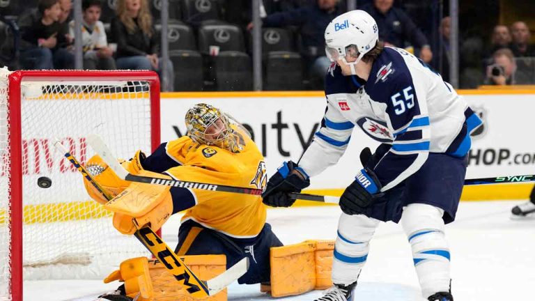 Winnipeg Jets' Mark Scheifele (55) scores a goal against Nashville Predators goaltender Juuse Saros during the first period of an NHL hockey game Tuesday, April 9, 2024, in Nashville, Tenn. (Mark Humphrey/AP)
