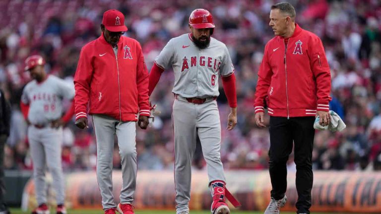 Los Angeles Angels Anthony Rendon (6) walks from the field with Los Angeles Angels manager Ron Washington, left, after hitting a single in the first inning of a baseball game against the Cincinnati Reds on Saturday, April 20, 2024, in Cincinnati. Rendon left the game after the play due to an injured ankle. (Carolyn Kaster/AP)