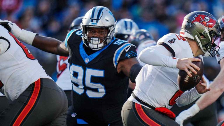 Carolina Panthers defensive tackle Derrick Brown (95) chases Tampa Bay Buccaneers quarterback Baker Mayfield (6) during the second half of an NFL football game, Sunday, Jan. 7, 2024, in Charlotte, N.C. (Rusty Jones/AP)