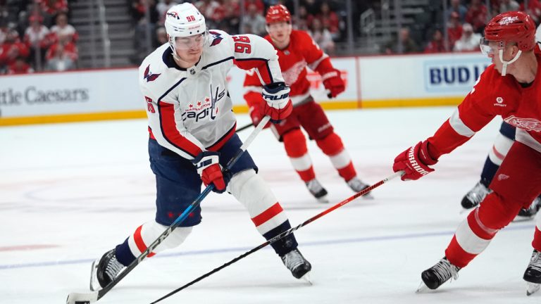 Washington Capitals right wing Nicolas Aube-Kubel (96) shoots on Detroit Red Wings defenseman Olli Maatta (2) in the first period of an NHL hockey game Tuesday, April 9, 2024, in Detroit. (Paul Sancya/AP)