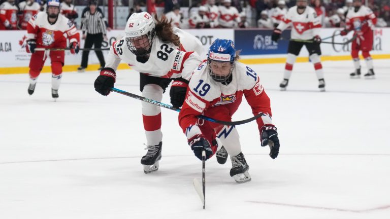 Czechia forward Natalie Mlynkova (19) battles for the puck against Switzerland defender Alessia Baechler (82) during second period bronze medal IIHF Women's World Hockey Championship hockey action in Brampton, Ont., on Sunday, April 16, 2023. Natalie Mlynkova has three goals and an assist as Czechia wrapped up third place in Group A at the world women's hockey championship with a 6-1 win over Switzerland on Tuesday. (Nathan Denette/CP)