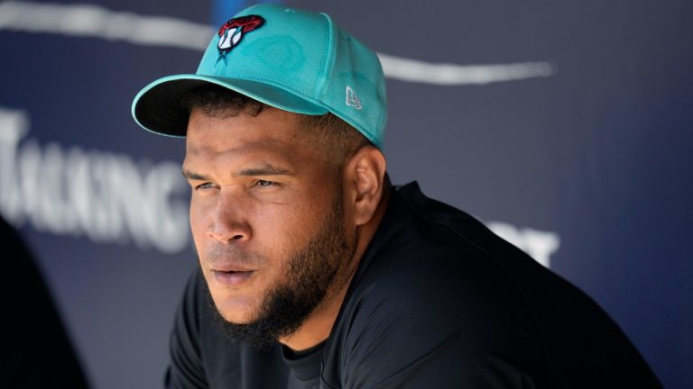 Arizona Diamondbacks starting pitcher Eduardo Rodriguez sits in the dugout during the first inning of a spring training baseball game against the San Diego Padres Tuesday, March 5, 2024, in Scottsdale, Ariz. (AP Photo/Ross D. Franklin)