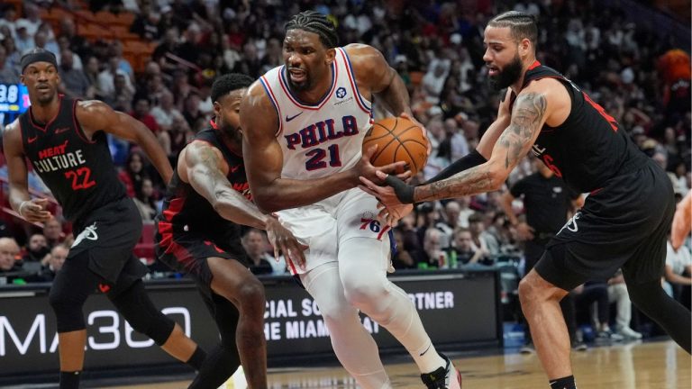 Philadelphia 76ers centre Joel Embiid breaks away from Miami Heat forward Haywood Highsmith and forward Caleb Martin during the first half of an NBA basketball game, Thursday, April 4, 2024, in Miami. (Marta Lavandier/AP Photo)