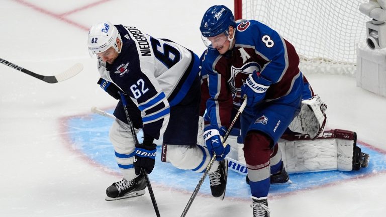 Winnipeg Jets right wing Nino Niederreiter, left, and Colorado Avalanche defenseman Cale Makar vie for the puck during the third period of Game 3 of an NHL hockey Stanley Cup first-round playoff series Friday, April 26, 2024, in Denver. (AP Photo/David Zalubowski)