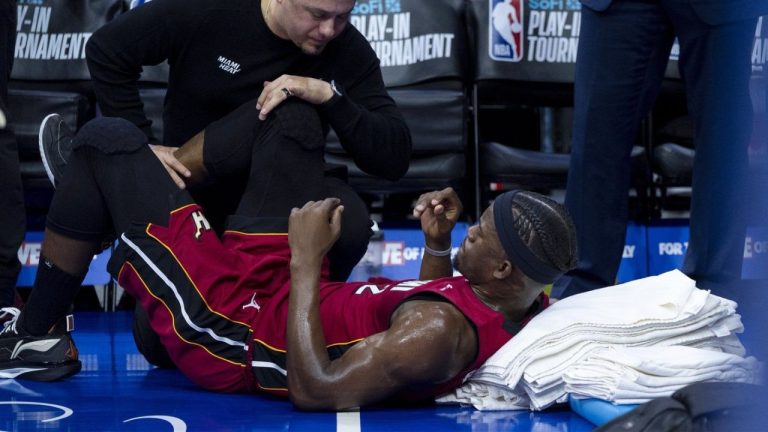 Miami Heat's Jimmy Butler gets treatment on his right knee from the training staff during the first half of the team's NBA basketball play-in tournament game against the Philadelphia 76ers, Wednesday, April 17, 2024, in Philadelphia. (Chris Szagola/AP Photo)