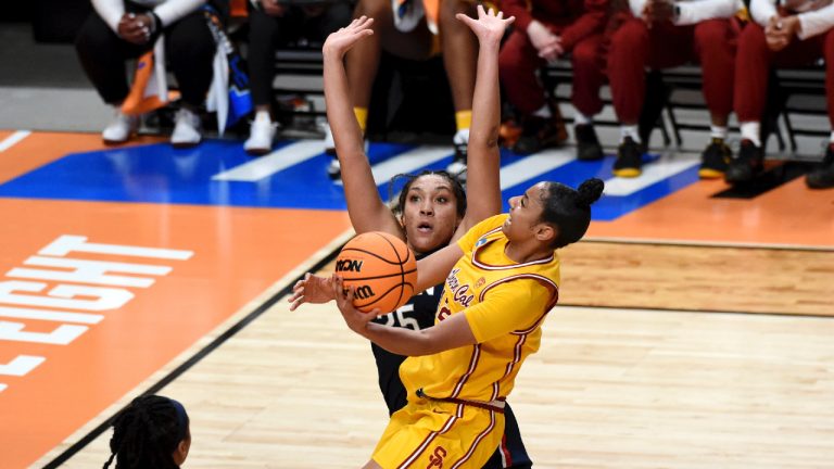 Southern California guard JuJu Watkins, right, drives to the basket against UConn forward Ice Brady, left, during the first half of an Elite Eight college basketball game in the women's NCAA Tournament, Monday, April 1, 2024, in Portland, Ore. (Steve Dykes/AP)