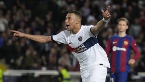 PSG's Kylian Mbappe celebrates after scoring his side's third goal during the Champions League quarterfinal second leg soccer match between Barcelona and Paris Saint-Germain at the Olimpic Lluis Companys stadium in Barcelona, Spain, Tuesday, April 16, 2024. (Emilio Morenatti/AP Photo)