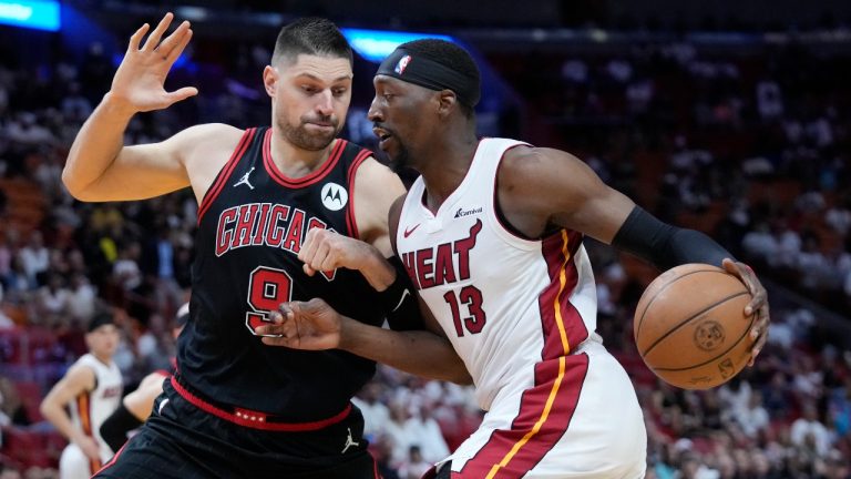 Miami Heat center Bam Adebayo (13) drives to the basket against Chicago Bulls center Nikola Vucevic (9) during the first half of an NBA basketball play-in tournament game, Friday, April 19, 2024, in Miami. (AP Photo/Wilfredo Lee)