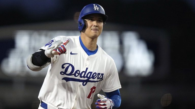 Los Angeles Dodgers' Shohei Ohtani gestures as he round third after hitting a solo home run during the first inning of a baseball game against the San Diego Padres Friday, April 12, 2024, in Los Angeles. (Mark J. Terrill/AP Photo)
