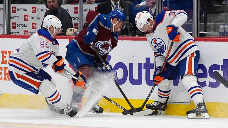 Colorado Avalanche left wing Zach Parise, center, works for control of the puck between Edmonton Oilers left wing Dylan Holloway, left, and center Sam Carrick during the second period of an NHL hockey game Thursday, April 18, 2024, in Denver. (David Zalubowski/AP)