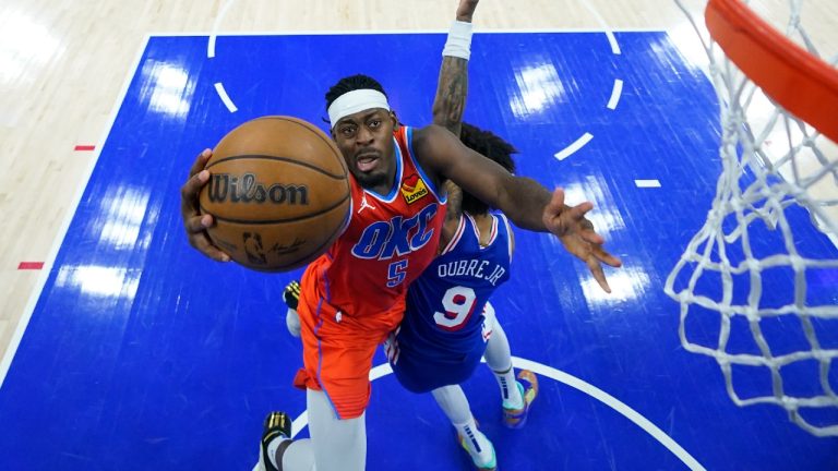 Oklahoma City Thunder's Luguentz Dort, left, goes up for a shot against Philadelphia 76ers' Kelly Oubre Jr. during the first half of an NBA basketball game, Tuesday, April 2, 2024, in Philadelphia. (Matt Slocum/AP)