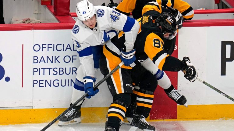 Pittsburgh Penguins' Sidney Crosby (87) checks Tampa Bay Lightning's Mitchell Chaffee (41) along the boards during the first period of an NHL hockey game in Pittsburgh, Saturday, April 6, 2024. (Gene J. Puskar/AP)