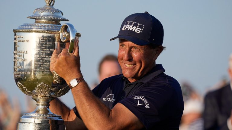 Phil Mickelson holds the Wanamaker Trophy after winning the PGA Championship golf tournament on the Ocean Course, Sunday, May 23, 2021, in Kiawah Island, S.C. (AP Photo/David J. Phillip)