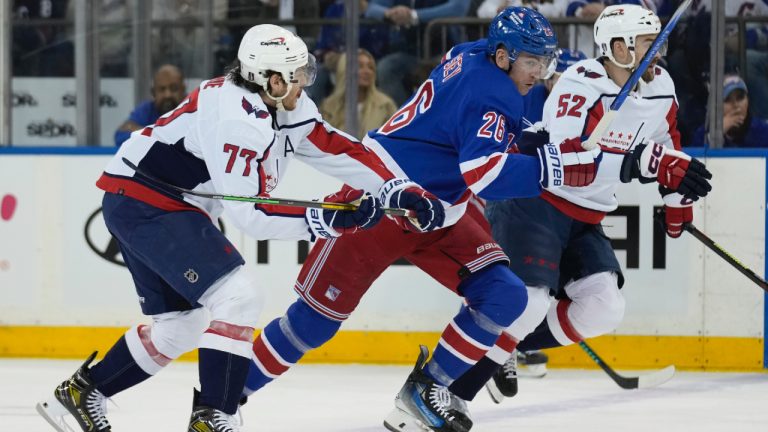 New York Rangers' Jimmy Vesey, centre, races for the puck with Washington Capitals' T.J. Oshie, left, and Dylan McIlrath during the first period in Game 1 of an NHL hockey Stanley Cup first-round playoff series, Sunday, April 21, 2024, in New York. (Seth Wenig/AP)
