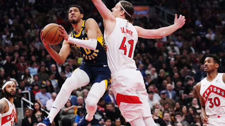 Indiana Pacers guard Tyrese Haliburton (0) drives to the net as Toronto Raptors forward Kelly Olynyk (41) defends during first half NBA basketball action in Toronto on Tuesday, April 9, 2024. (Nathan Denette/CP)