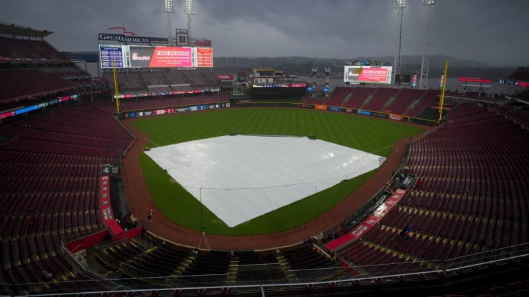 A view of the tarp on the field as rain falls before a baseball game against the Milwaukee Brewers and the Cincinnati Reds in Cincinnati. (Aaron Doster/AP)