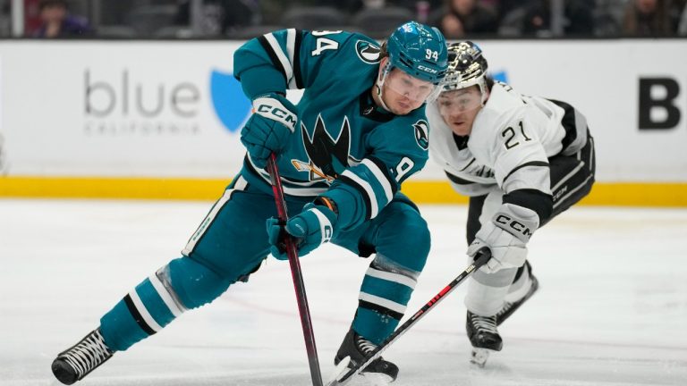 San Jose Sharks left wing Alexander Barabanov (94) controls the puck against Los Angeles Kings defenseman Jordan Spence (21) during the third period of an NHL hockey game Monday, Jan. 22, 2024, in Los Angeles. (AP Photo/Ashley Landis)