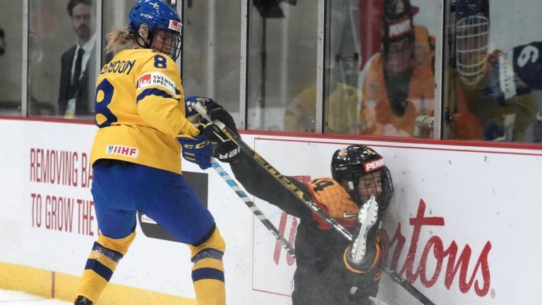 Hilda Svensson had two goals and an assist as Sweden thumped China 8-1 Friday at the world women's hockey championship. Germany defender Carina Strobel (14) crashes into the boards as she battles for the puck against Svensson (8) during first-period IIHF Women's World Hockey Championship hockey action in Brampton, Ont., on Thursday, April 6, 2023. (Nathan Denette/CP)