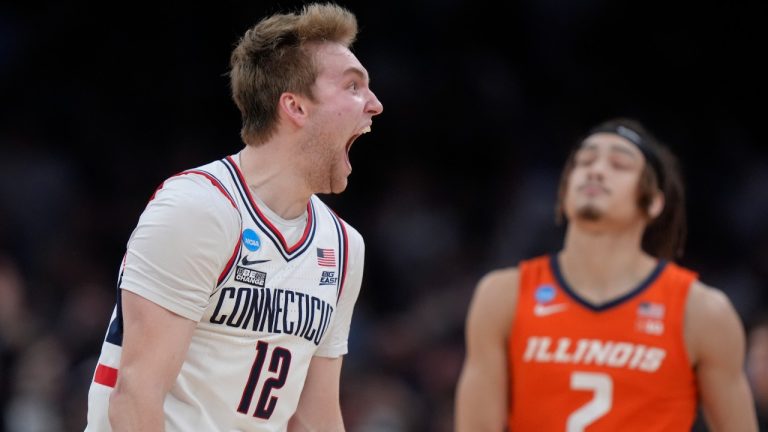 UConn guard Cam Spencer (12) celebrates during the second half of the Elite 8 college basketball game against against the Illinois in the men's NCAA Tournament, Saturday, March 30, 2024, in Boston. (AP Photo/Steven Senne)