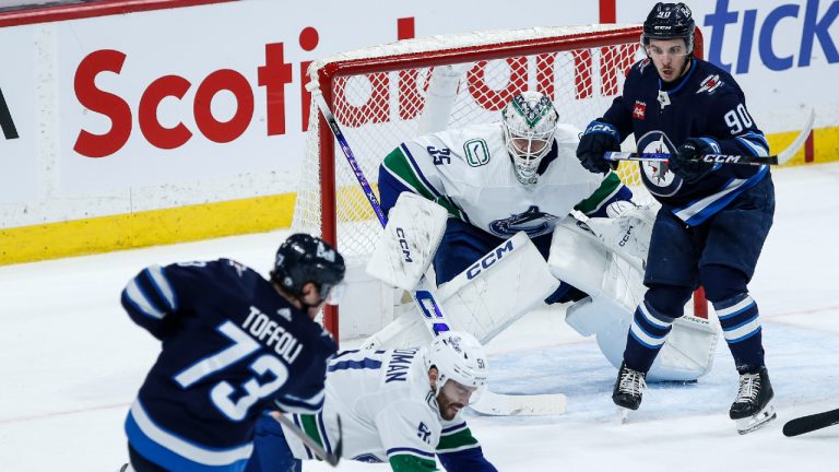 Vancouver Canucks' Mark Friedman (51) drops to block a shot from Winnipeg Jets' Tyler Toffoli (73) during first period NHL action in Winnipeg on Thursday, April 18, 2024. (John Woods/CP)