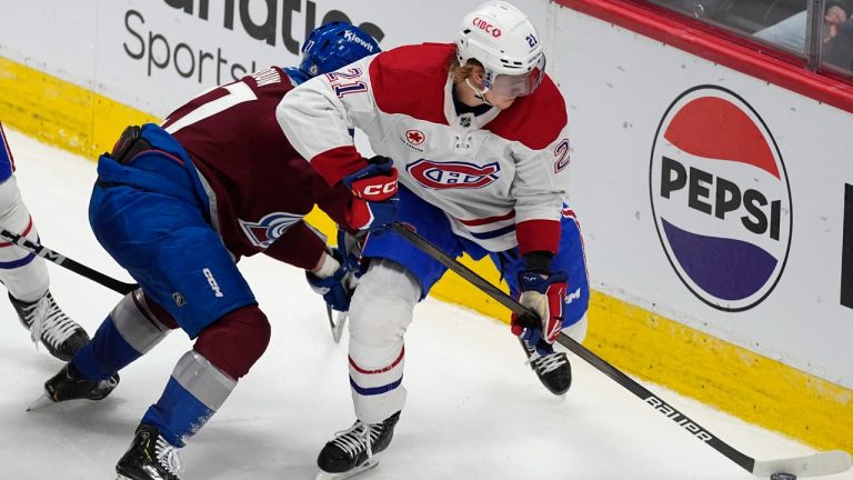 Montreal Canadiens defenceman Kaiden Guhle, right, collects the puck as Colorado Avalanche left wing Jonathan Drouin defends during the third period of an NHL hockey game Tuesday, March 26, 2024, in Denver. (David Zalubowski/AP)