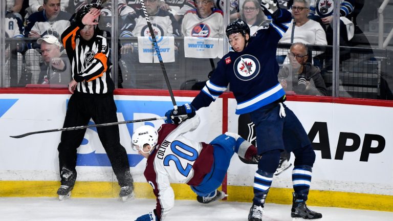Colorado Avalanche's Ross Colton (20) collides with Winnipeg Jets' Logan Stanley (64) during the first period in Game 1 of their NHL hockey Stanley Cup first-round playoff series in Winnipeg on Sunday April 21, 2024. (Fred Greenslade/THE CANADIAN PRESS)