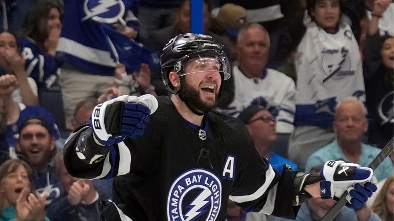 Tampa Bay Lightning right wing Nikita Kucherov celebrates after assisting on a goal by centre Brayden Point against the Toronto Maple Leafs during the second period of an NHL hockey game Wednesday, April 17, 2024, in Tampa, Fla. The assist was Kucherov's 100th of the season. (Chris O'Meara/AP Photo)