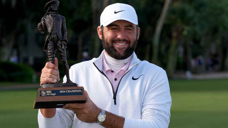 Scottie Scheffler holds the trophy after winning the weather delayed RBC Heritage golf tournament. (Chris Carlson/AP)