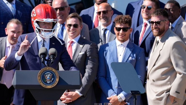 Kansas City Chiefs quarterback Patrick Mahomes, second from right, and Kansas City Chiefs tight end Travis Kelce, right, watch as President Joe Biden wears a Chiefs helmet as he speaks during an event with the Super Bowl-champion Kansas City Chiefs on the South Lawn of the White House, Friday, May 31, 2024, to celebrate their championship season and victory in Super Bowl LVIII. (Evan Vucci/AP)