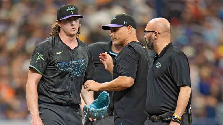 Tampa Bay Rays starting pitcher Ryan Pepiot, left, is taken out of the game against the New York Mets by manager Kevin Cash, center, and trainer Joe Benge after getting hit on the foot by a ground ball by New York Mets' Starling Marte during the third inning of a baseball game Sunday, May 5, 2024, in St. Petersburg, Fla. (Chris O'Meara/AP)