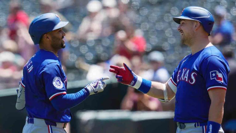 Texas Rangers' Marcus Semien, left, celebrates with Nathaniel Lowe after hitting a solo home run against the Oakland Athletics during the first inning of a baseball game Tuesday, May 7, 2024, in Oakland, Calif. (Godofredo A. Vásquez/AP)
