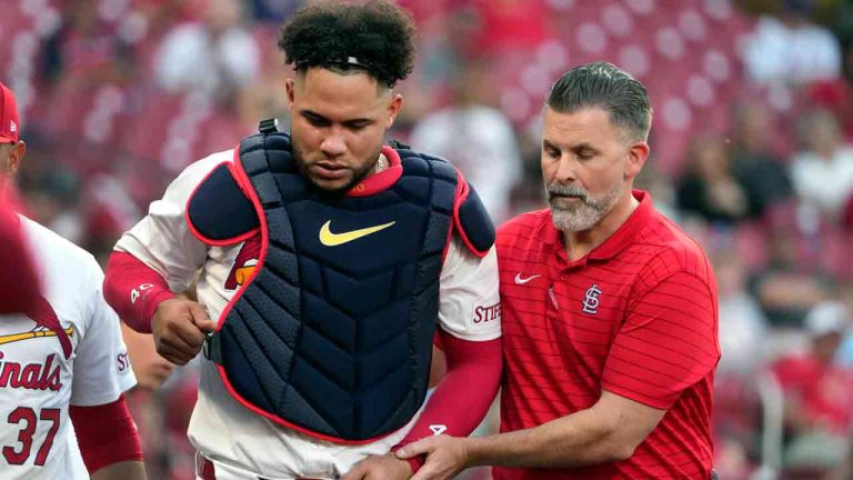St. Louis Cardinals catcher Willson Contreras, left, is helped off the field by trainer Adam Olsen, right, after being injured during the second inning of a baseball game against the New York Mets Tuesday, May 7, 2024, in St. Louis. Contreras left the game. (Jeff Roberson/AP)
