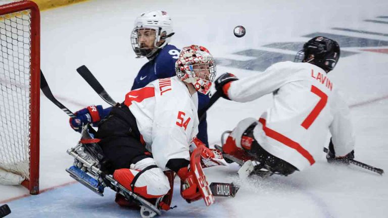 Team USA forward Travis Dodson (9) has his shot deflected by Team Canada goalie Adam Kingsmill (54) during second period action in the World Para Ice Hockey Championship final in Calgary, Sunday, May 12, 2024. (Jeff McIntosh/CP)
