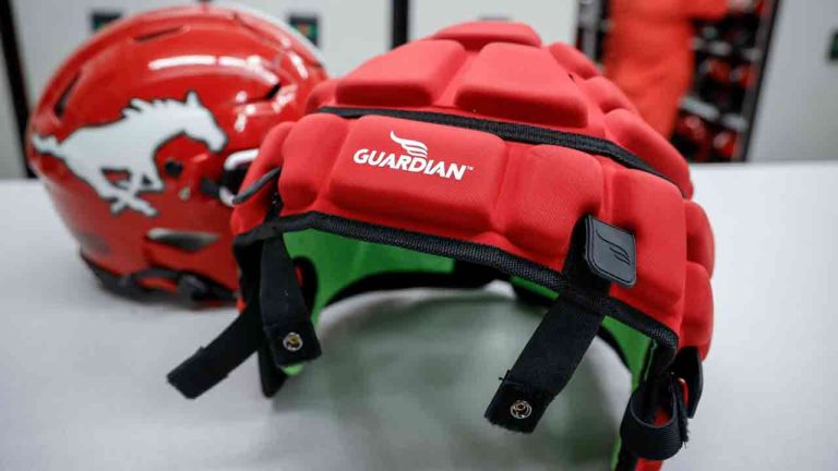 CFL players will have the option of wearing Guardian caps during games this season but mouthguards will be mandatory. A Guardian cap and a non-covered helmet are displayed at a Calgary Stampeders practice in Calgary on Tuesday, June 6, 2023. (Jeff McIntosh/CP)