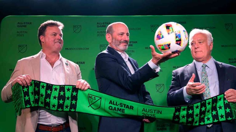 Major League Soccer Commissioner Don Garber, center, catches a soccer ball as he stands with Majority Owner and Chief Executive Officer of Austin FC Anthony Precourt, left, and Austin Mayor Kirk Watson, right, after announcing that Austin FC will host the 2025 MLS All-Star soccer game, Wednesday, May 15, 2024, in Austin, Texas. (Eric Gay/AP)