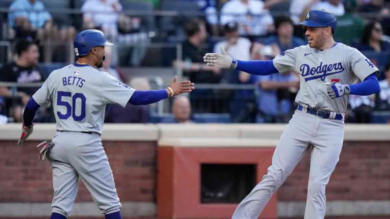 Los Angeles Dodgers' Mookie Betts (50) celebrates with Freddie Freeman (5) after they scored on a a two-run home run by Freeman during the tenth inning in the first baseball game of a doubleheader Tuesday, May 28, 2024, in New York. (Frank Franklin II/AP)