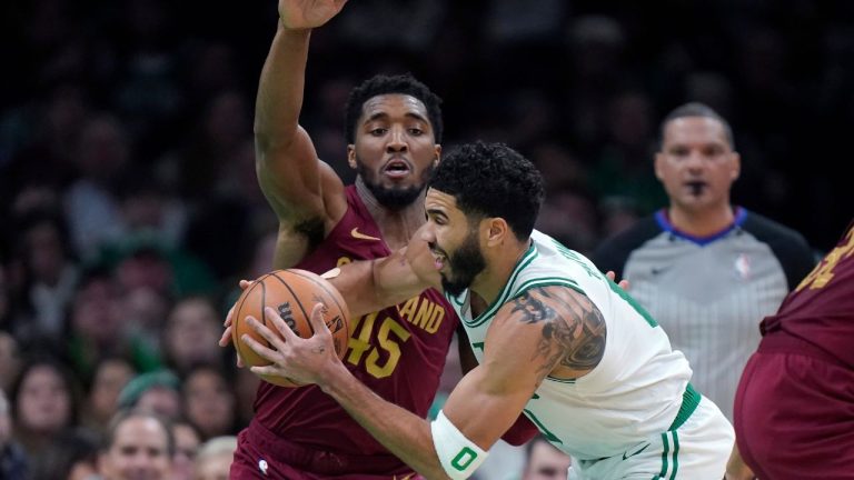 Boston Celtics forward Jayson Tatum prepares to pass the ball as Cleveland Cavaliers guard Donovan Mitchell defends during the second half of an NBA basketball game Thursday, Dec. 14, 2023, in Boston. (Steven Senne/AP Photo)