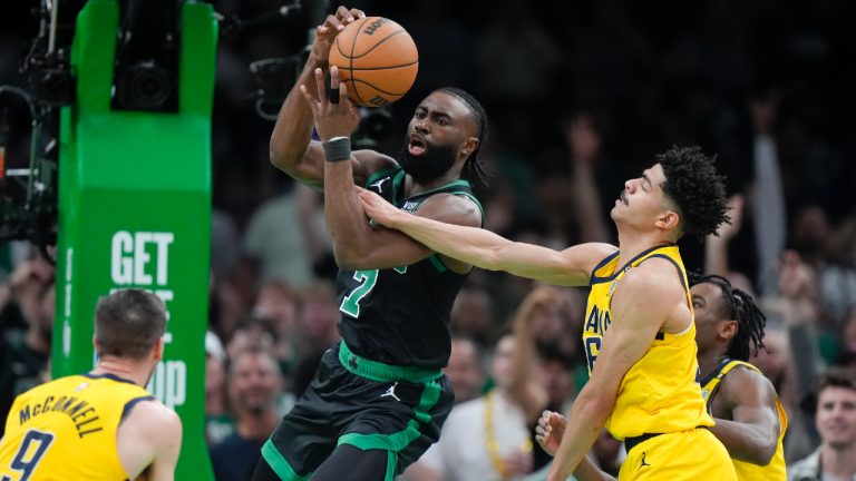 Boston Celtics guard Jaylen Brown (7) grabs a rebound next to Indiana Pacers guard Ben Sheppard, right, during the first half of Game 2 of the NBA Eastern Conference basketball finals Thursday, May 23, 2024, in Boston. (Steven Senne/AP)