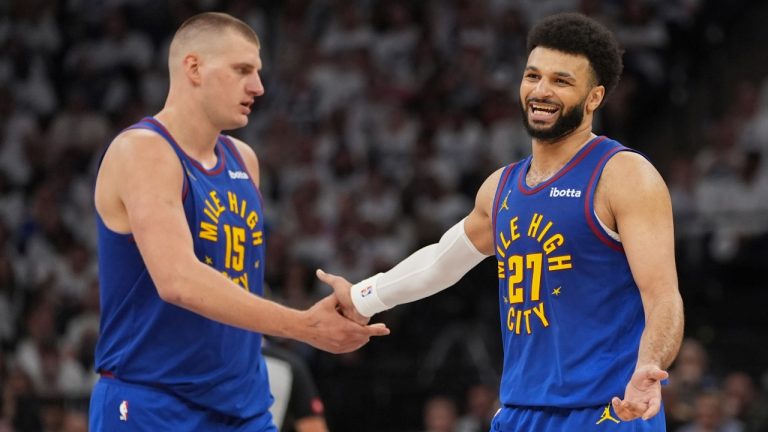 Denver Nuggets center Nikola Jokic (15) and guard Jamal Murray (27) slap hands during the second half of an NBA basketball game. (Abbie Parr/AP)
