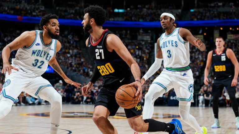 Denver Nuggets guard Jamal Murray, center, drives to the basket between Minnesota Timberwolves center Karl-Anthony Towns, left, and forward Jaden McDaniels in the first half of Game 7 of an NBA second-round playoff series, Sunday, May 19, 2024, in Denver. (David Zalubowski/AP)