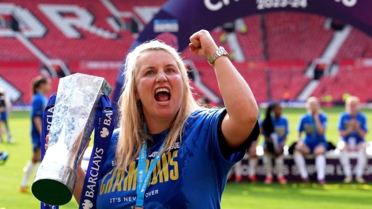 Chelsea manager Emma Hayes celebrates with the trophy after winning the English Women's Super League soccer match between Manchester United and Chelsea at Old Trafford, in Manchester, England, Saturday, May 18, 2024. (Martin Rickett/PA via AP)