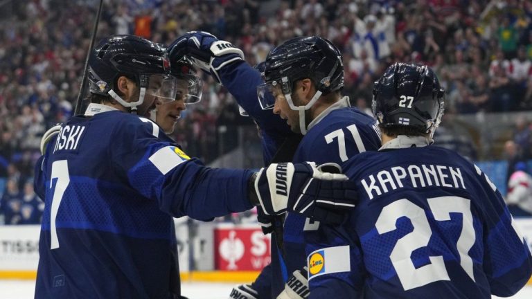 Finland's Oliver Kapanen, right, celebrates with teammates after scoring his sides first goal during the preliminary round match between Finland and Great Britain at the Ice Hockey World Championships in Prague, Czech Republic, Sunday, May 12, 2024. (AP/Petr David Josek)