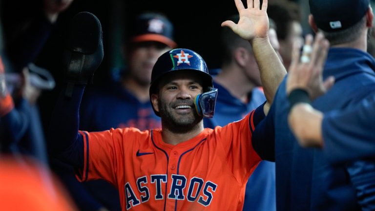 Houston Astros' Jose Altuve (27) celebrates scoring against the Detroit Tigers in the eighth inning of a baseball game, Friday, May 10, 2024, in Detroit. (AP Photo/Paul Sancya)