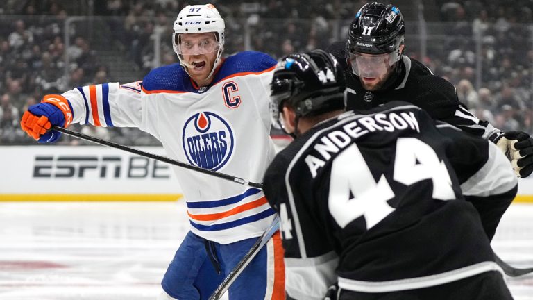 Edmonton Oilers centre Connor McDavid, left, battles with Los Angeles Kings centre Anze Kopitar, right, and defenceman Mikey Anderson during the third period in Game 4 of an NHL hockey Stanley Cup first-round playoff series Sunday, April 28, 2024, in Los Angeles. (Mark J. Terrill/AP)