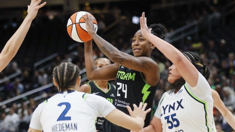 Seattle Storm guard Jewell Loyd passes the ball against the Minnesota Lynx defence during the first quarter of a WNBA basketball game Tuesday, May 14, 2024, in Seattle. (Jennifer Buchanan/The Seattle Times via AP)