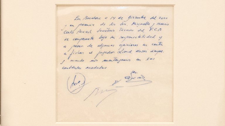 A Bonhams staff member holds up a napkin on which a written commitment was made to then 13-year-old soccer player Lionel Messi from Argentina for a contract from FC Barcelona in December 2000 is on display at Bonhams in London, England, Wednesday, May 8, 2024 before it is offered at auction. (Jordan Pettitt/PA via AP)