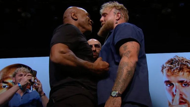 Mike Tyson, left, and Jake Paul face off at a press conference to promote their upcoming heavyweight boxing fight set to air on Netflix. (YouTube/Netflix)