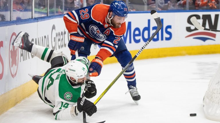 Dallas Stars' Jamie Benn (14) is checked by Edmonton Oilers' Leon Draisaitl (29) during first period third-round NHL playoff action in Edmonton on Monday May 27, 2024. (Jason Franson/CP)