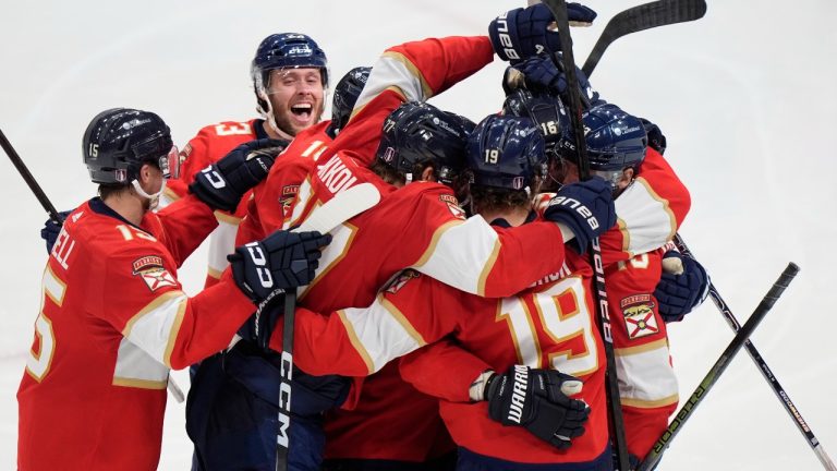 Florida Panthers center Sam Reinhart, far right, is mobbed by teammates after he scored during an overtime period of Game 4 during the Eastern Conference finals of the NHL hockey Stanley Cup playoffs to beat the New York Rangers, Tuesday, May 28, 2024, in Sunrise, Fla. (AP/Wilfredo Lee)