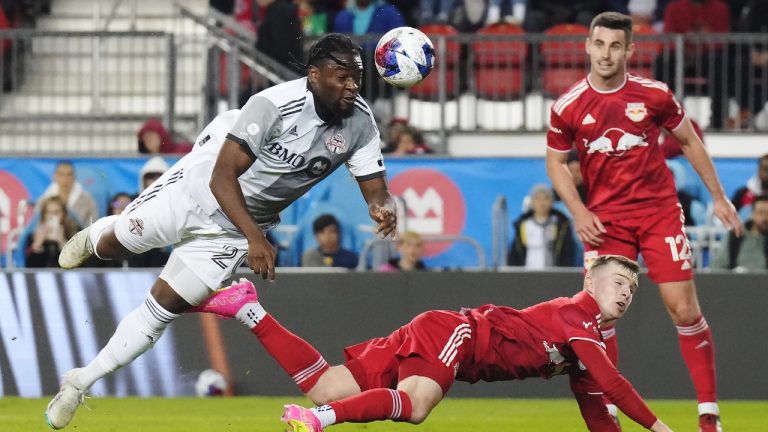 Toronto FC forward Ayo Akinola (20) heads the ball as New York Red Bulls forward Cameron Harper (17) defends and defender Dylan Nealis (12) looks on during second half MLS soccer action in Toronto on Wednesday, May 17, 2023. (Chris Young/CP)